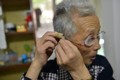 Old man with hearing aid